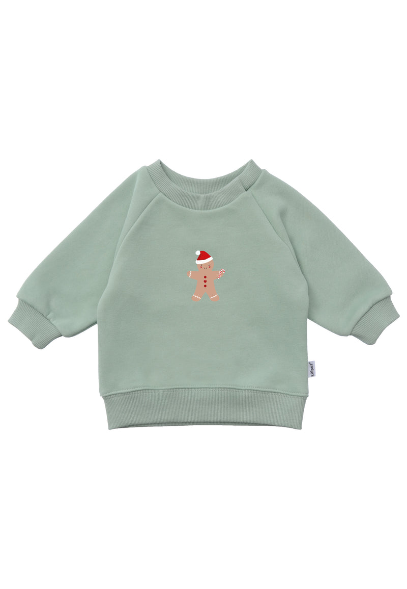 Frontansicht des schilf farbenden Sweaters mit Lebkuchen Aufdruck.
