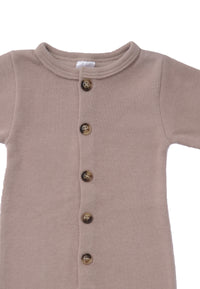 Detailansicht des weichen Ribstrick Overalls in warmen braun Ton.